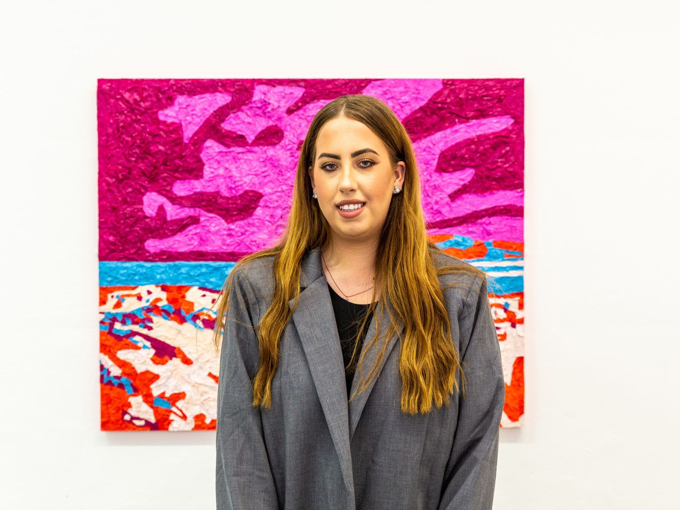 Sarah MacFarlane poses with artwork