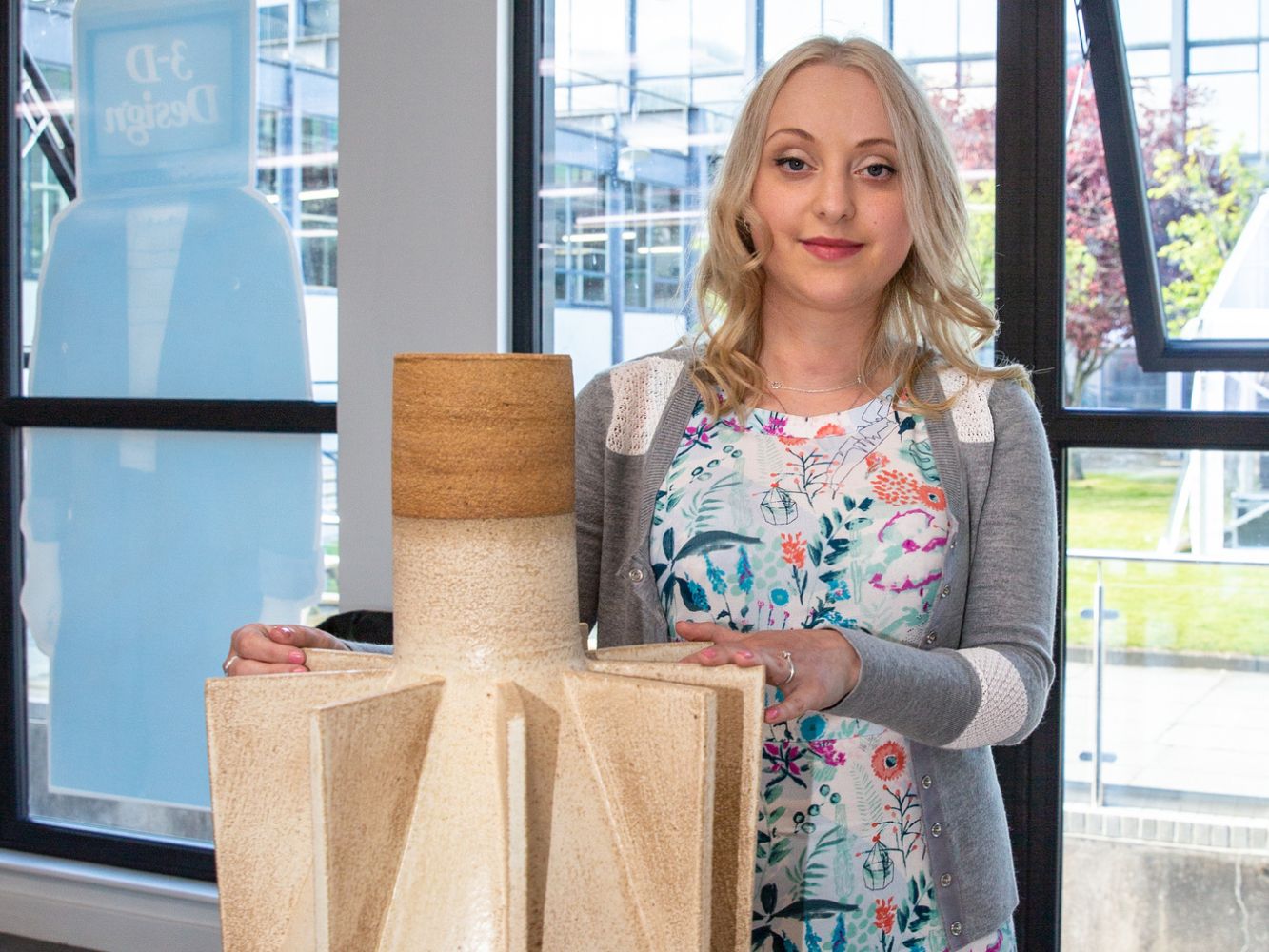 Valeriya Omelechkyna poses with artwork