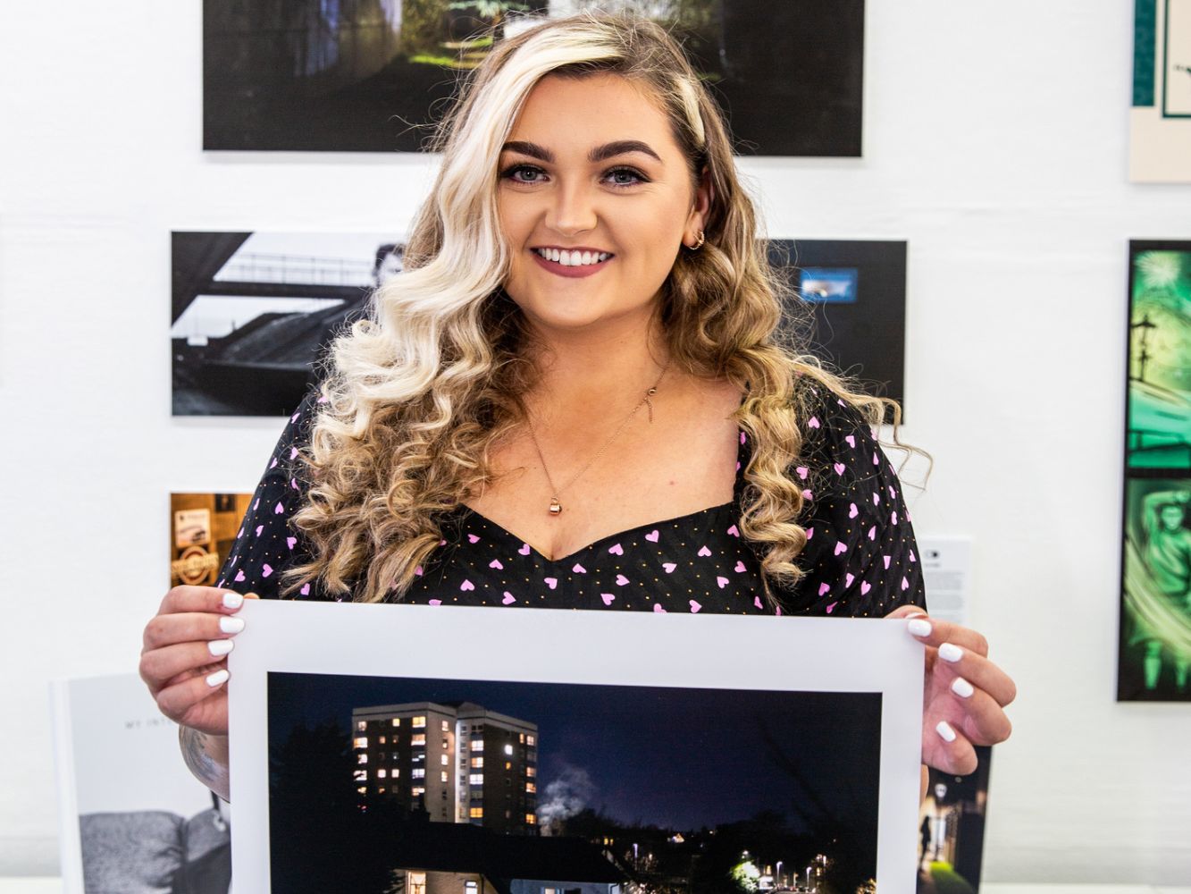 Zoe Neil poses with artwork