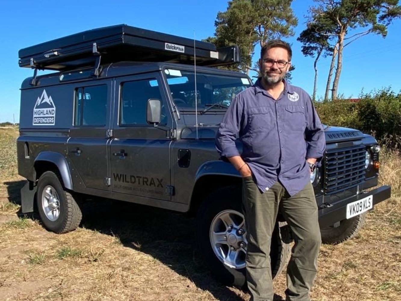 Craig Dutton poses by car