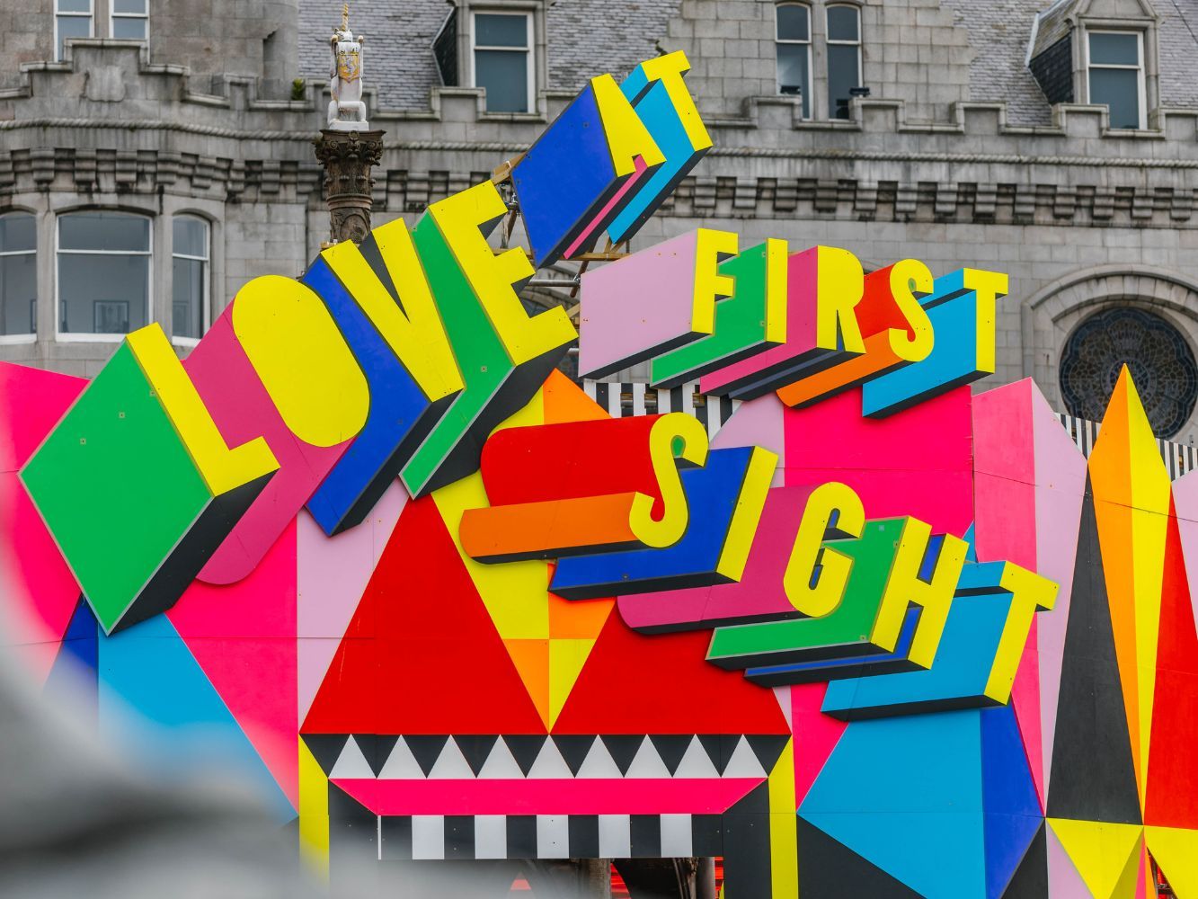 Morag Myerscough Art Installation at Aberdeen's Castlegate vibrant sign that reads 'Love at First Sight'