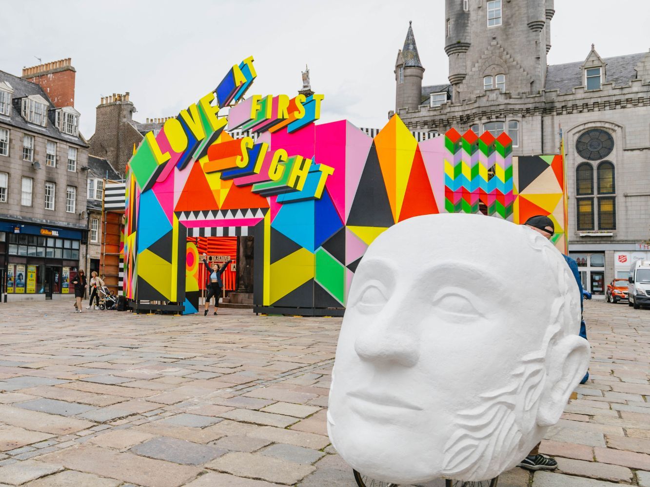 Morag Myerscough Art Installation at Aberdeen's Castlegate including sculpture of man's head in forefront