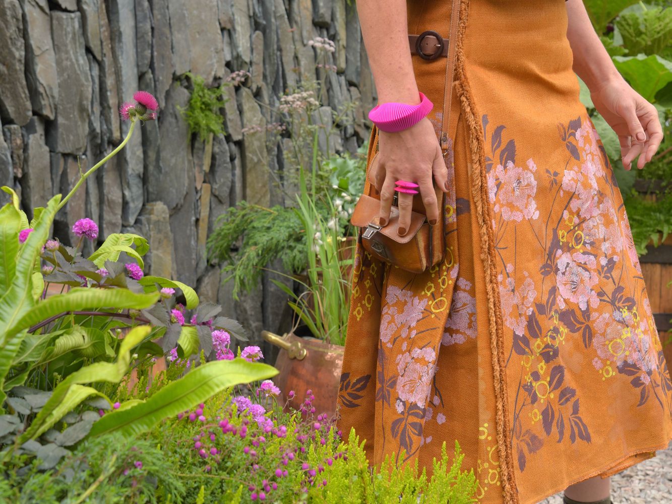 Close up of skirt with floral print in a garden