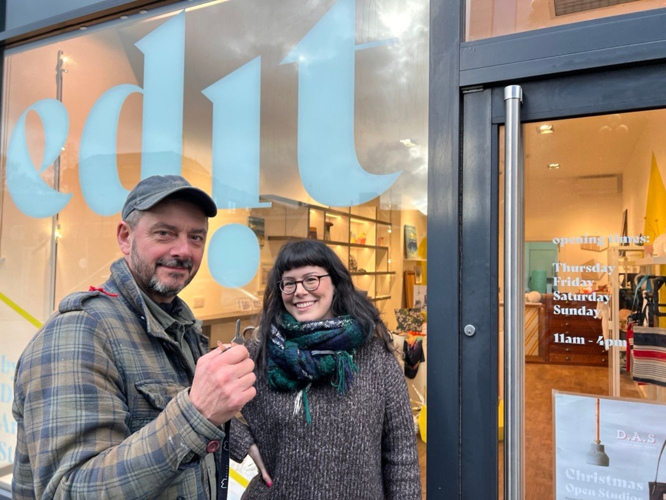 Two people stand outside Culture Aberdeen Project's pop up artists space at Bon Accord