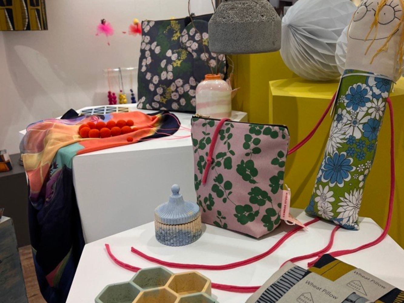 A display of bags, scarves, jewellery and pots
