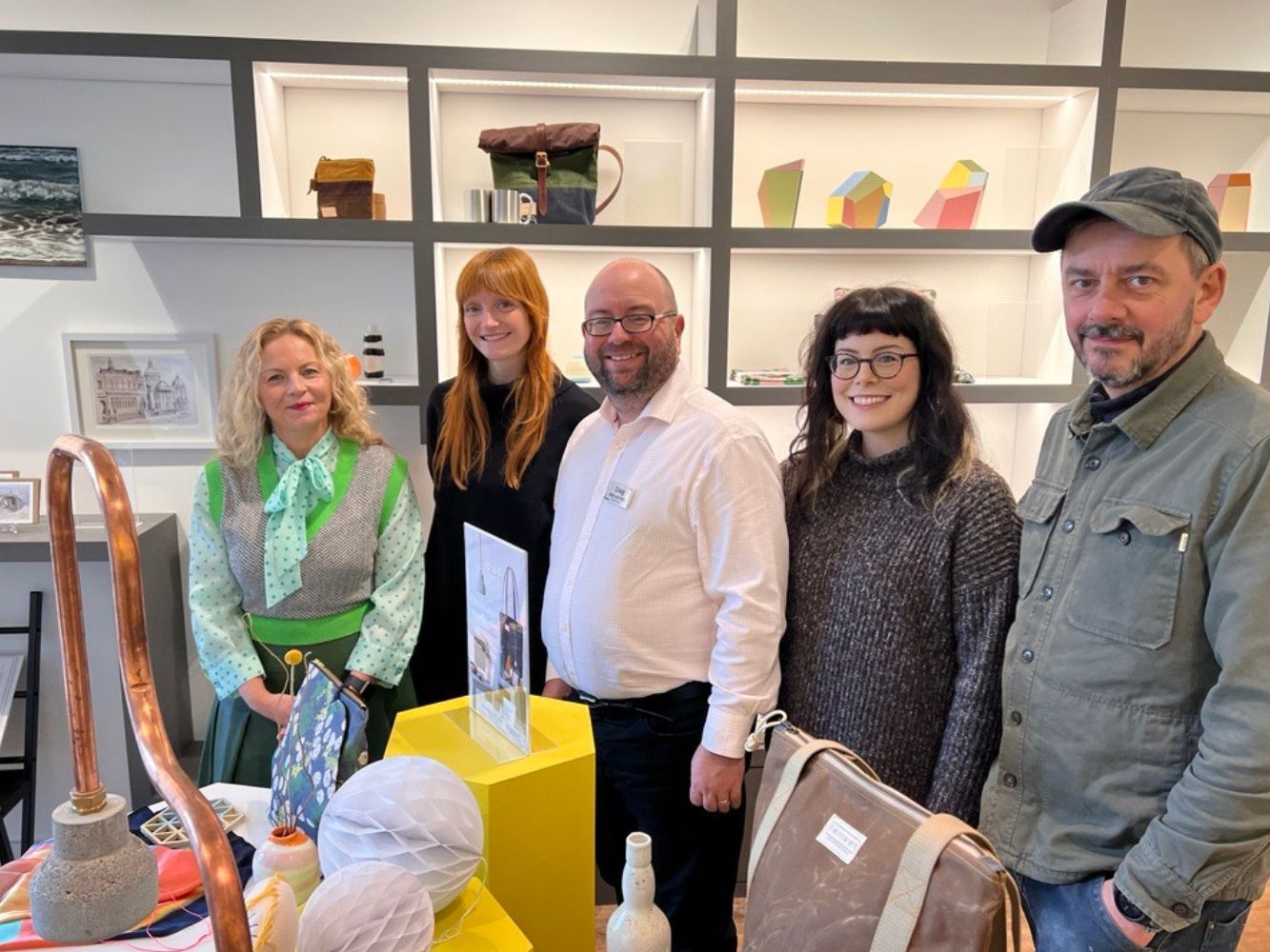 5 representatives from Gray's, Look Again and Bon Accord stand inside the pop up artists space