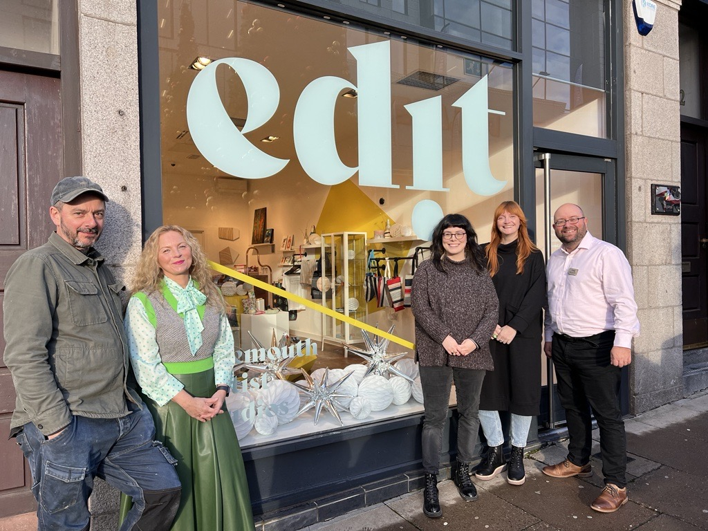Representatives from Look Again and Bon Accord stand outside creative space at Bon Accord