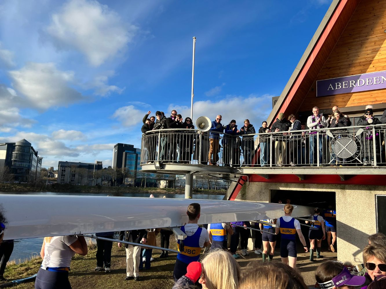 UoA first crew enter the Boat Club to applause