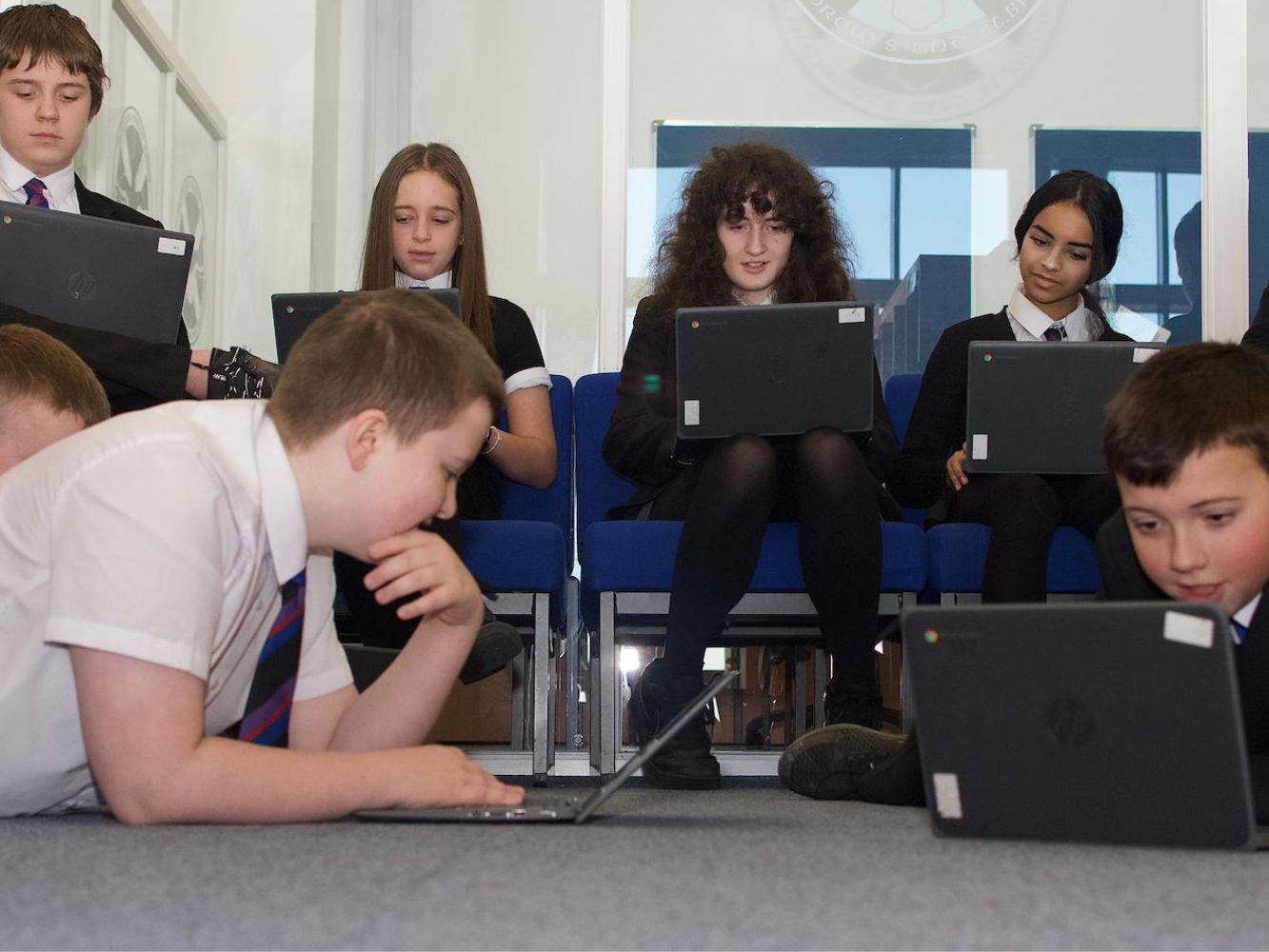 School pupils working on laptops