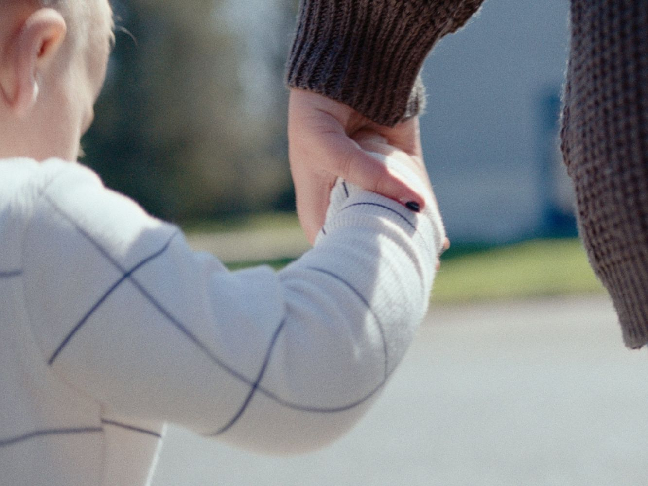 Mother and child holding hands