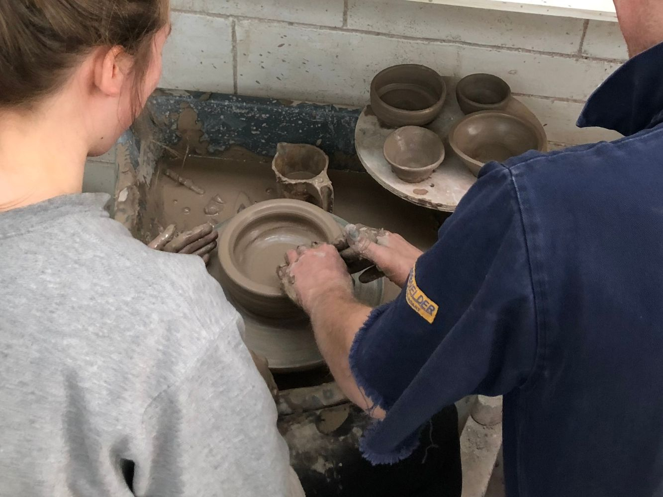 Two people doing pottery
