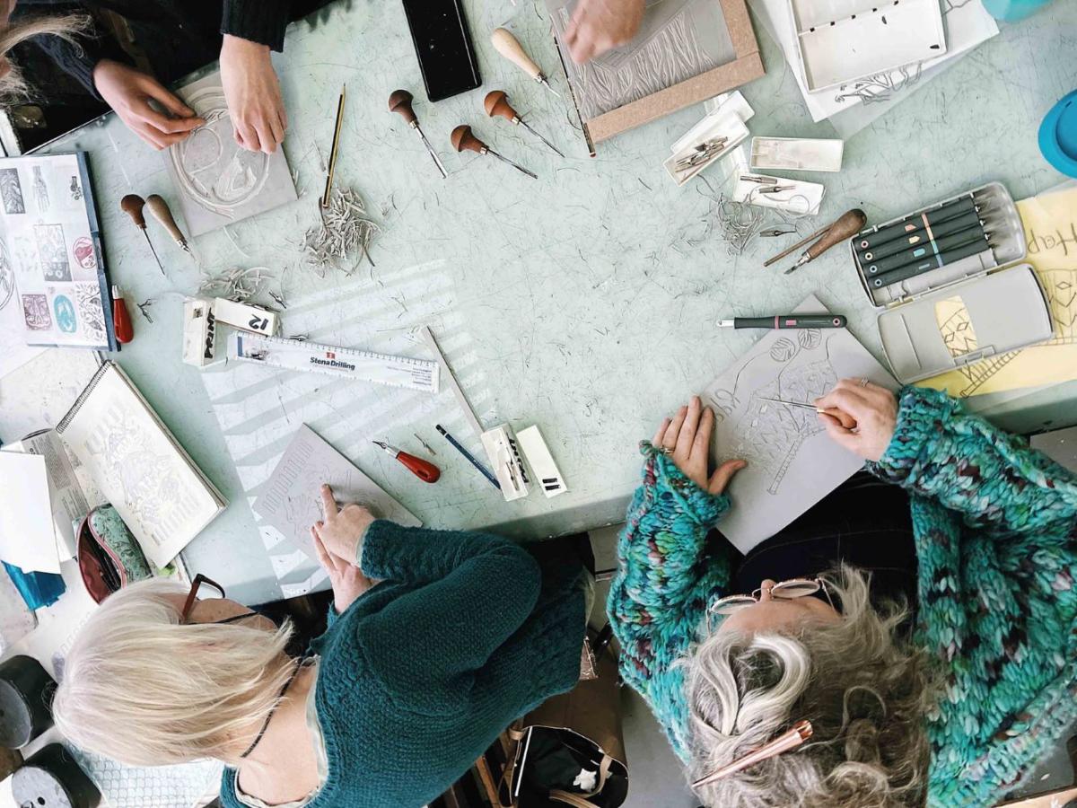 People engaging in a creative workshop seen from above