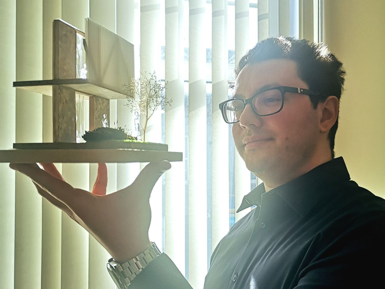 Marco Antonio Paz-Garcia holding small architectural model