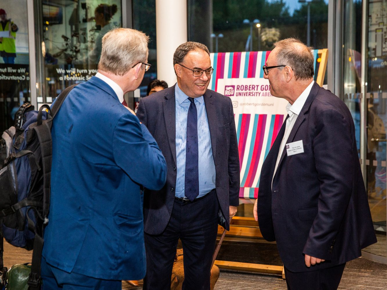 William Dowson, Andrew Bailey and Paul de Leeuw converse as they arrive at RGU.