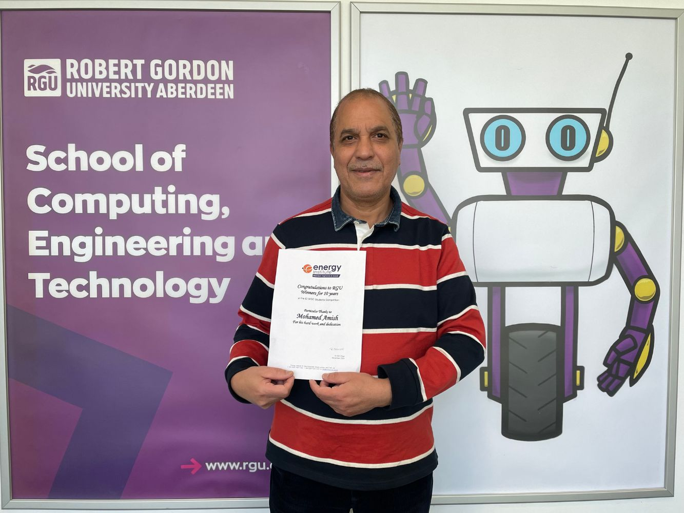 Mohamed Amish with his EI certificate