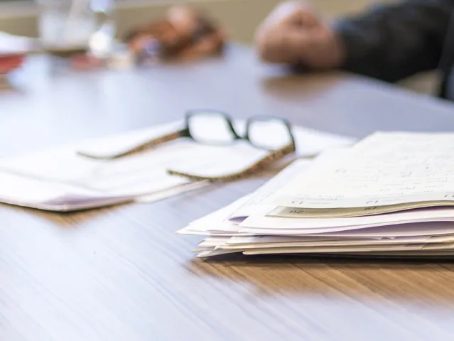 notebook and eyeglasses sitting on table