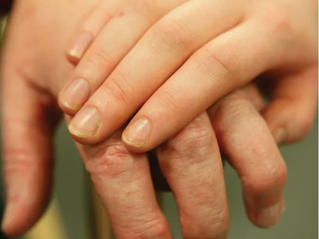 younger hand holding older hand