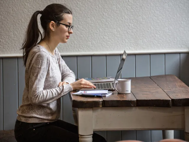 woman working on laptop in cafe