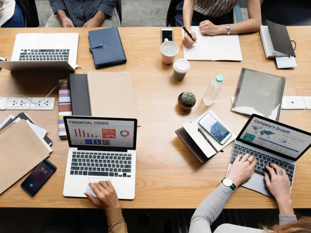 people using laptops on a desk