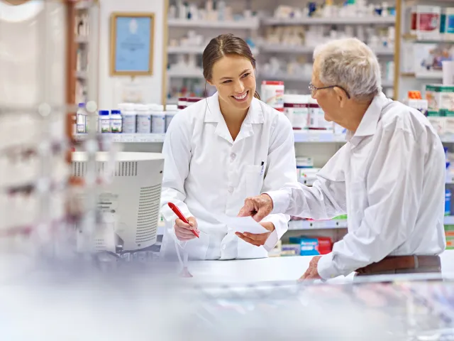 pharmacist showing medication to a patient