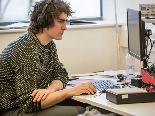student looking at computer in lab