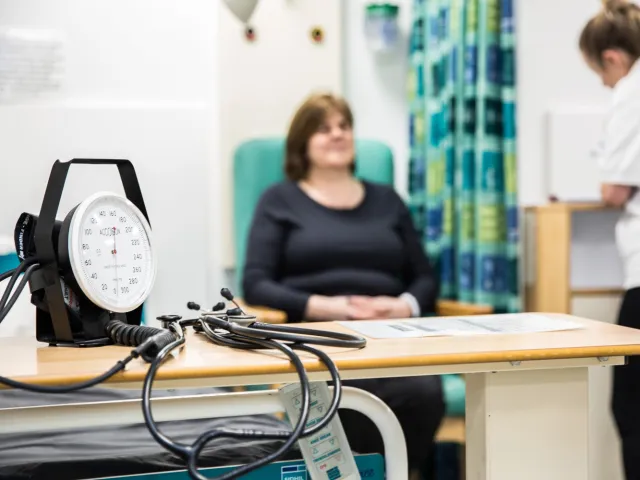 patient sitting next to medical equipment