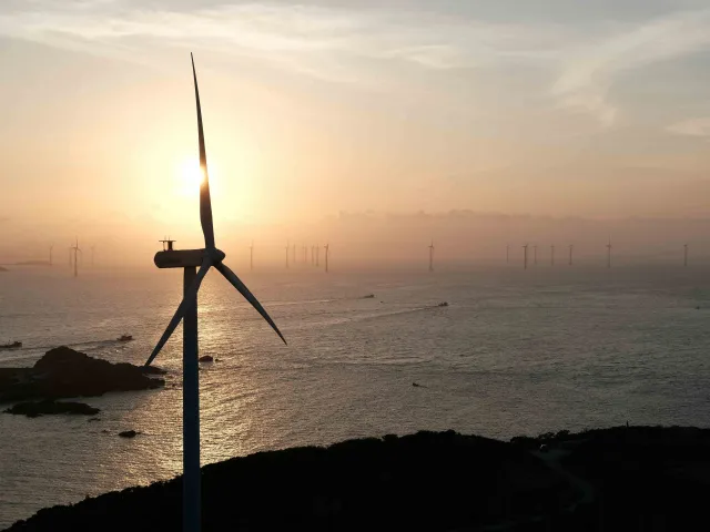 wind turbines by the ocean