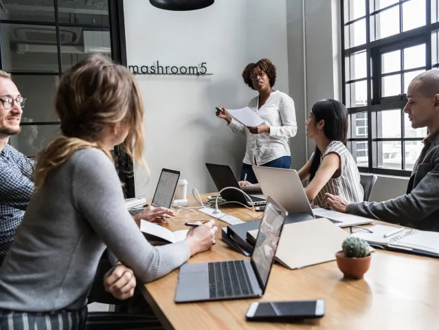 people having a meeting with laptops on the table
