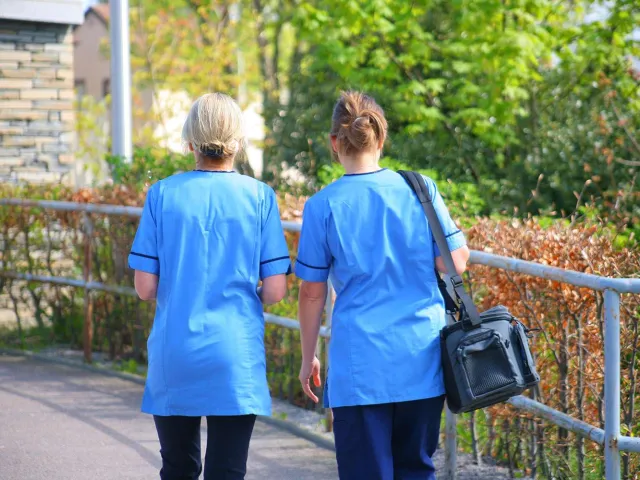 two health professionals walking outdoors