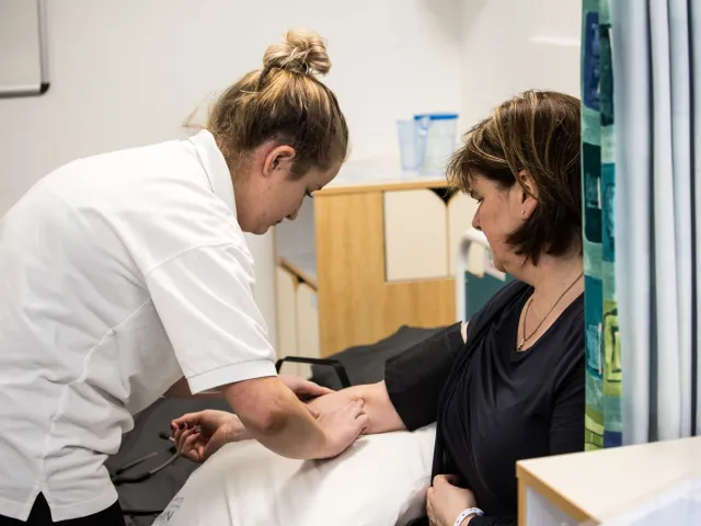 student nurse taking someone's pulse