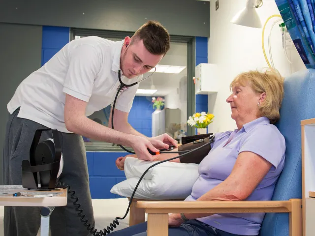 student nurse taking patients blood pressure