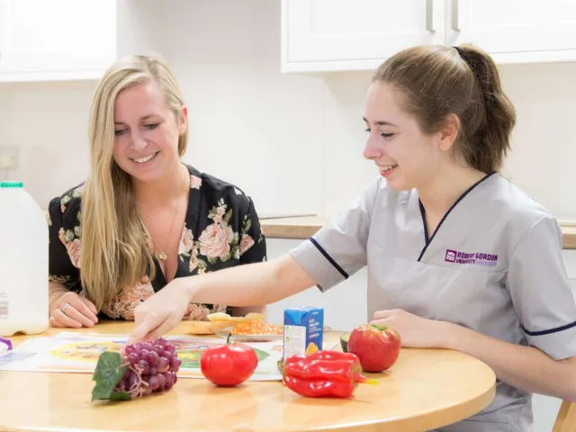 health and dietetics student looking at foods on a table