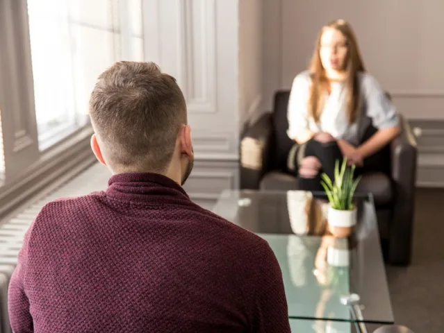 two people in a room having a serious conversation