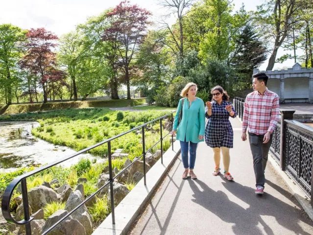 students walking around duthie park in the sunshine