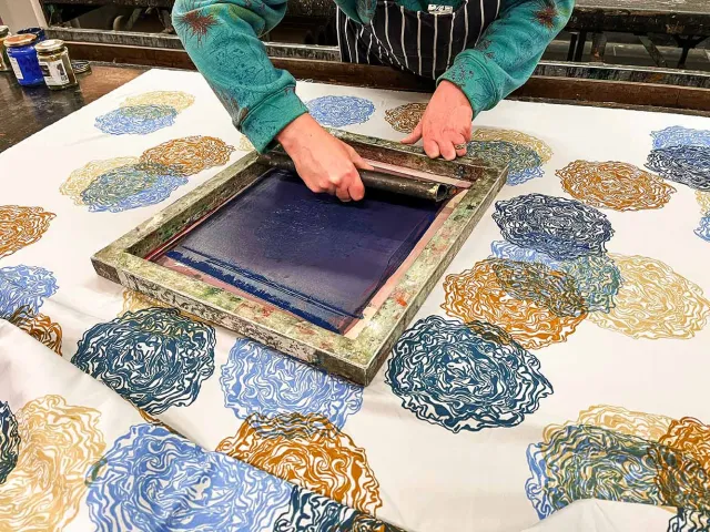 Student screenprinting a pattern