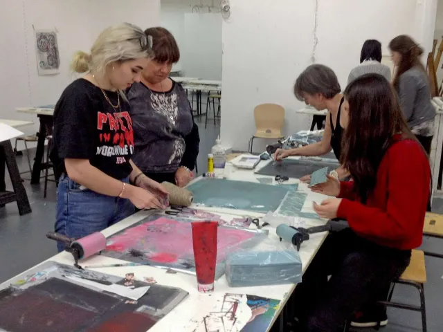 People working on artwork portfolios