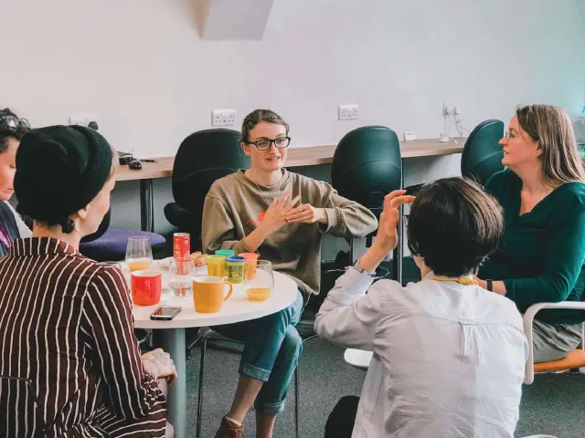 group of people chatting around a table