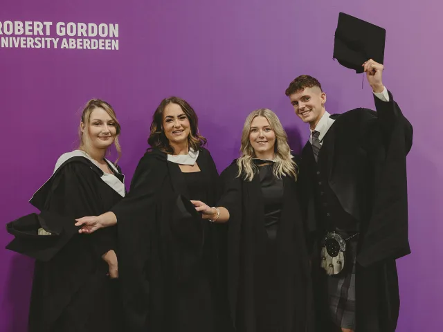 Four RGU graduates pose for a photograph together at P&J Live