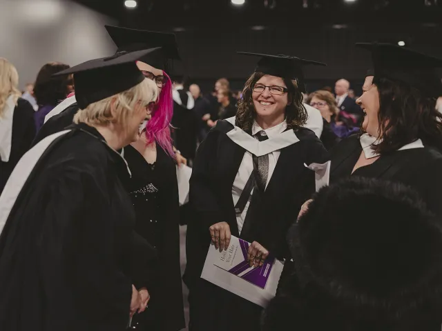 Four RGU graduates laugh together at P&J Live