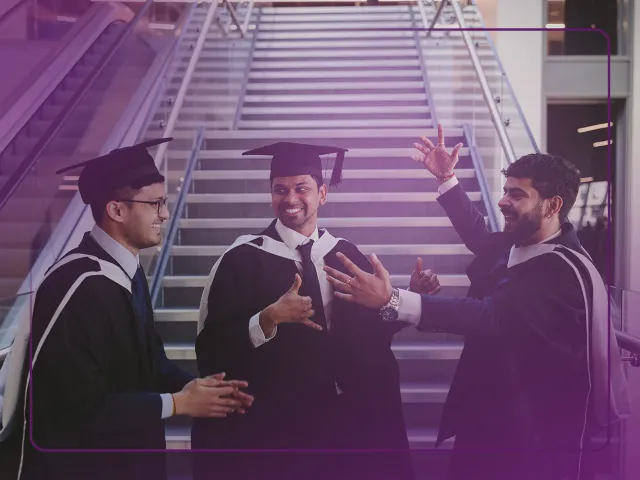 3 students celebrating at graduation
