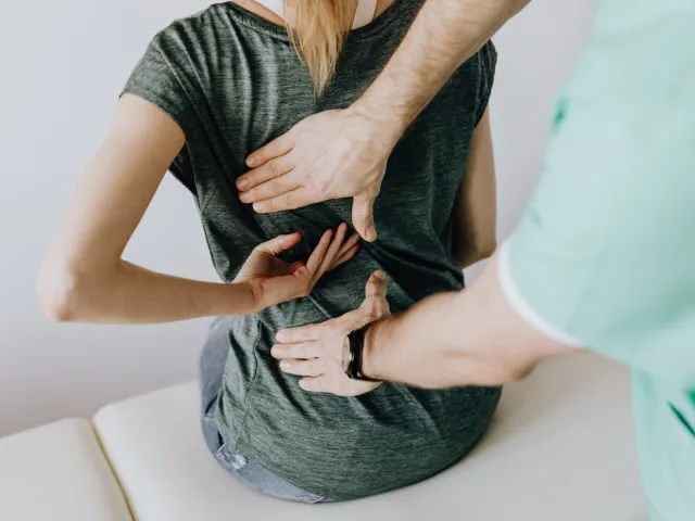 health professional pressing a patients back