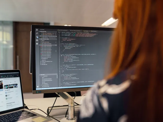 person writing code on a computer