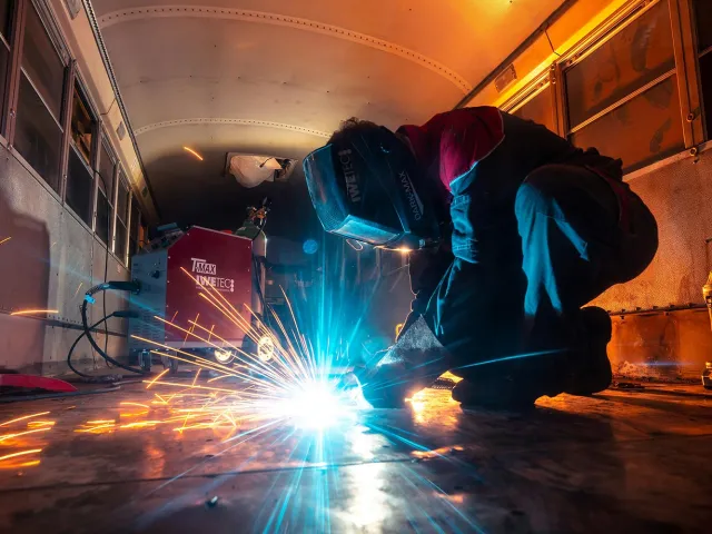 A welder wearing a mask
