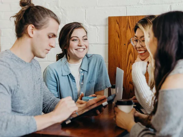 group of people chatting around a table