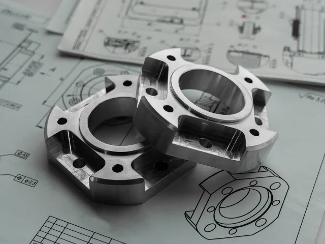 metal gearing sat on some drawn engineering diagrams