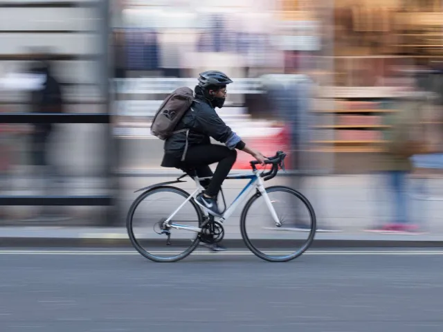 cyclist travelling down a busy street