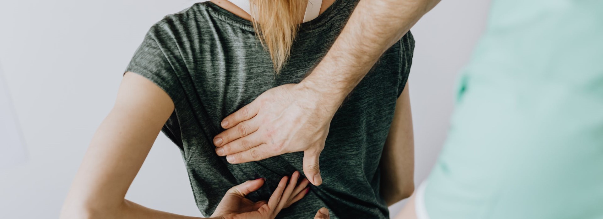 health professional pressing a patients back
