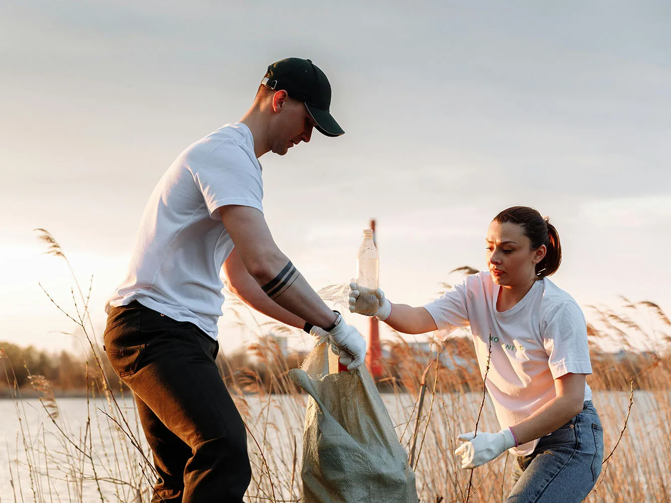 Two people collecting litter