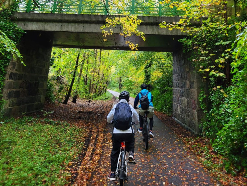 Cyclists going under a bridge near RGU