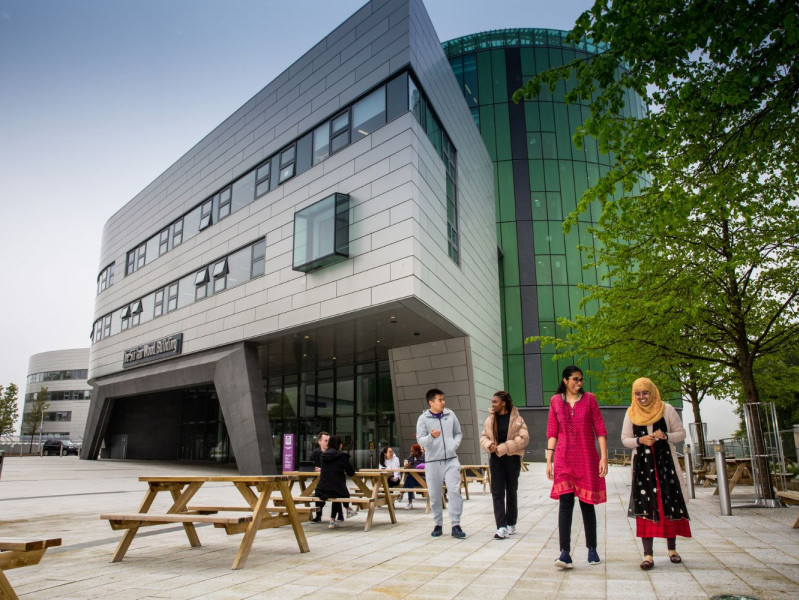 Four RGU students walking away from the Sir Ian Wood Building